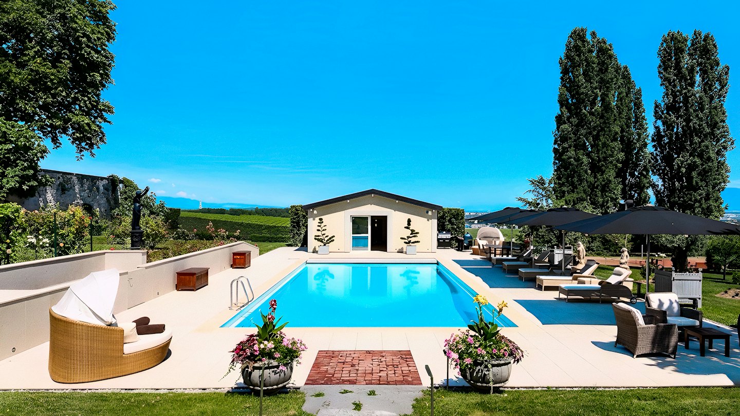 Des chaises longues bordent une piscine dans une villa de campagne.